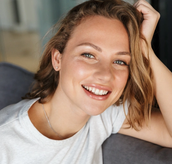 Smiling woman with long hair representing cosmetic dentistry services