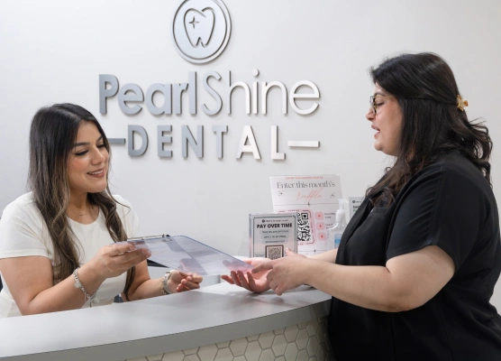Dental staff member discussing insurance and financing options