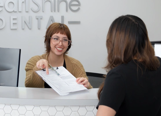 Dental team member assisting a new patient