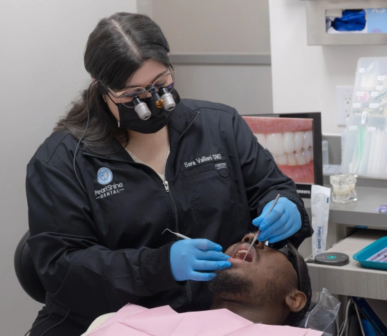 Patient receiving TMD treatment from a dentist