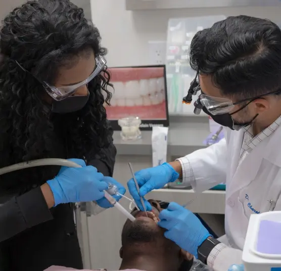 Dentist performing tooth extraction procedure on patient in Houston dental office.