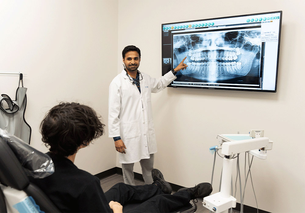 Dr. Charolia pointing to an x-ray with a patient