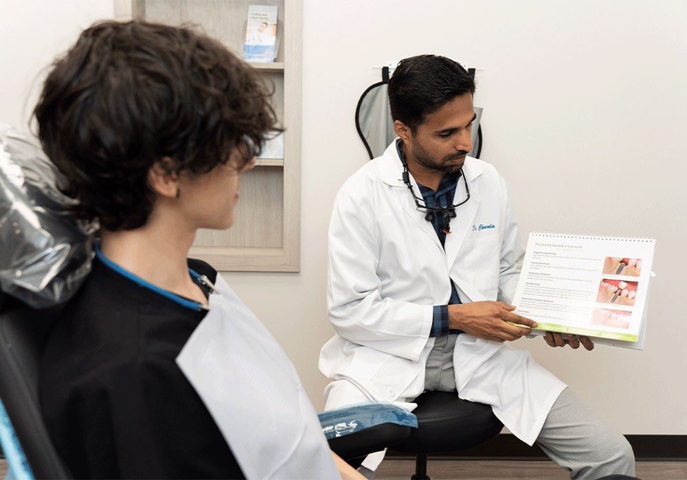 Dr. Charolia showing a patient an information booklet