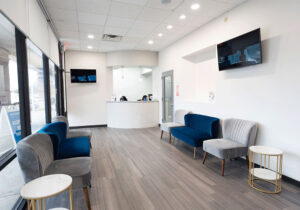 front office with front desk, TVs, chairs, and sidetables
